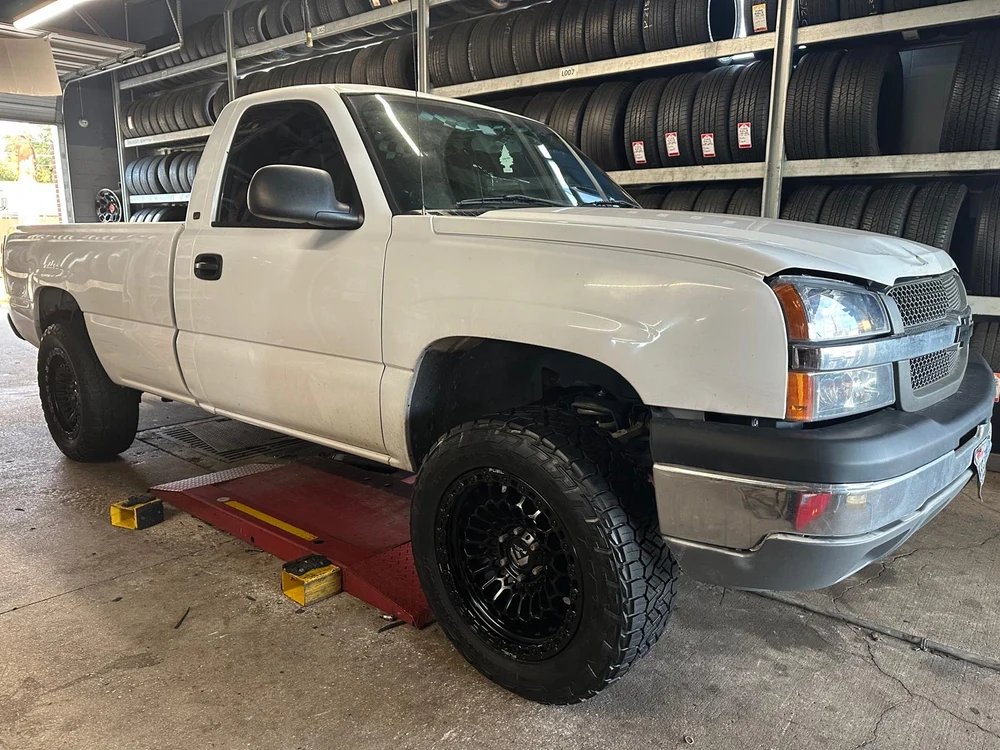 Chevy Silverado after new black off-road wheels and Nitto tires installed at Morton Tire and Wheels (MTW) in Katy, TX