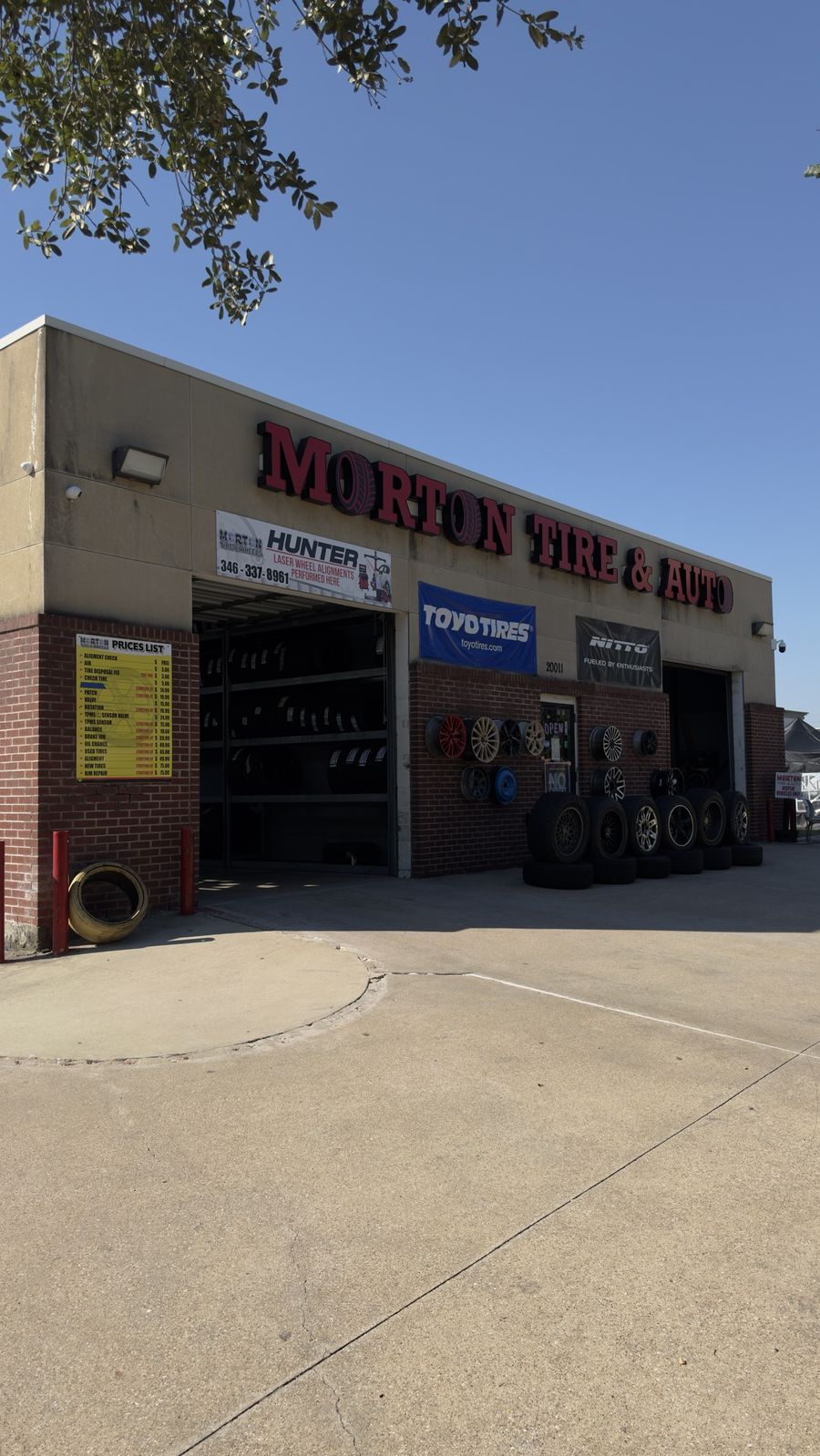 Morton Tire and Wheels storefront at 20011 Morton Rd in Katy, TX, with Toyo and Nitto banners and wheels on display